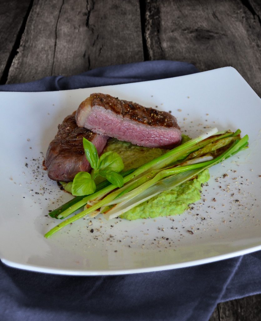 Kleines Steak auf Erbsenpüree mit gebratenen Lauchzwiebeln