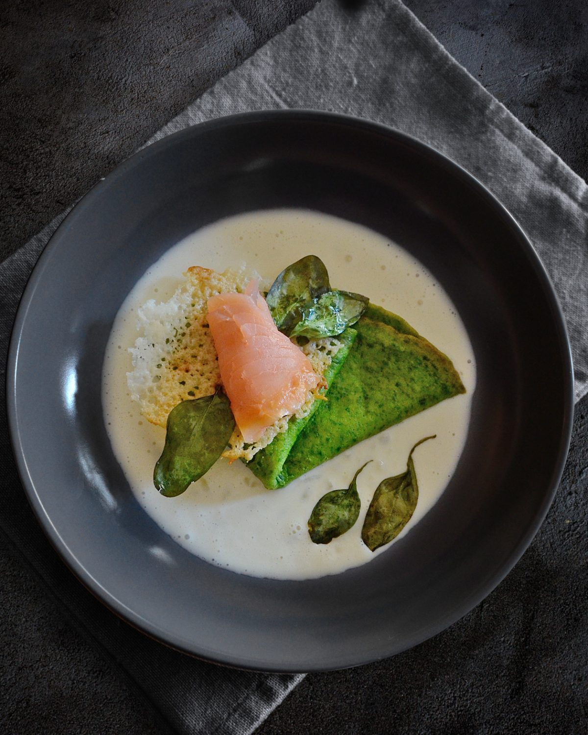 Spinatpfannkuchen mit Räucherlachs auf Parmesan-Schaum